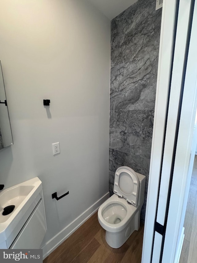 3003 Gaul St, Philadelphia, PA 19134 - half bathroom with vanity, toilet, wood finished floors, and baseboards