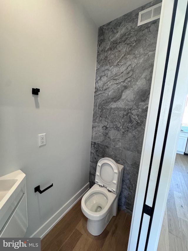 3003 Gaul St, Philadelphia, PA 19134 - bathroom with tile walls, toilet, visible vents, and wood finished floors