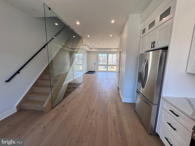 3003 Gaul St, Philadelphia, PA 19134 - kitchen featuring baseboards, light wood finished floors, white cabinetry, open floor plan, and stainless steel fridge with ice dispenser