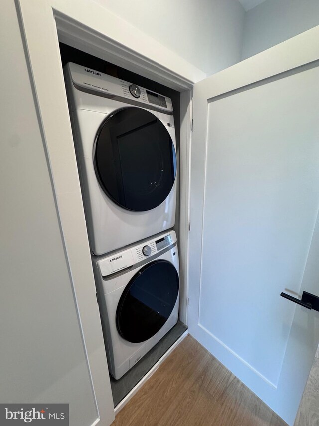 3003 Gaul St, Philadelphia, PA 19134 - laundry room featuring laundry area, stacked washer and clothes dryer, and wood finished floors