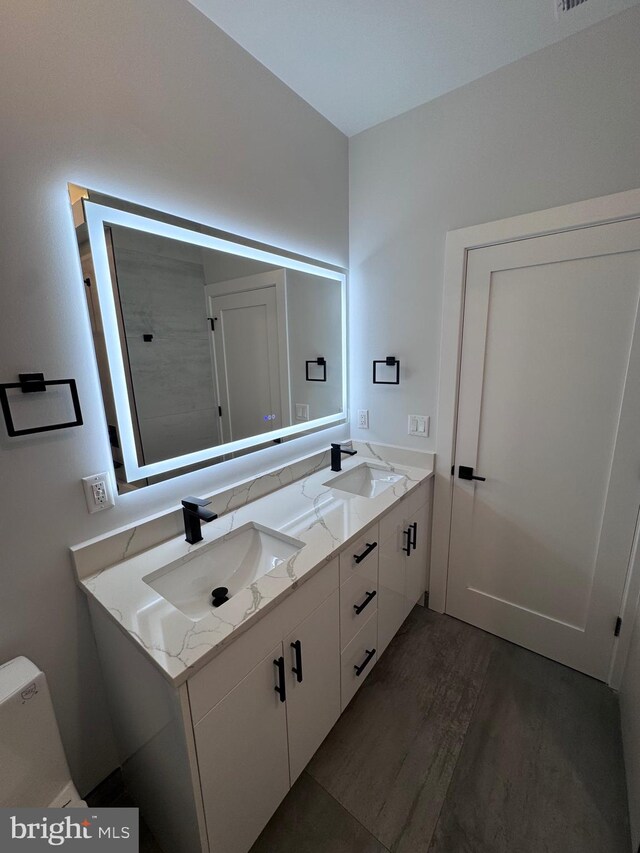 3003 Gaul St, Philadelphia, PA 19134 - full bath featuring double vanity, a sink, and wood finished floors