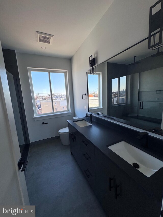 3003 Gaul St, Philadelphia, PA 19134 - full bathroom featuring a sink, double vanity, toilet, and visible vents