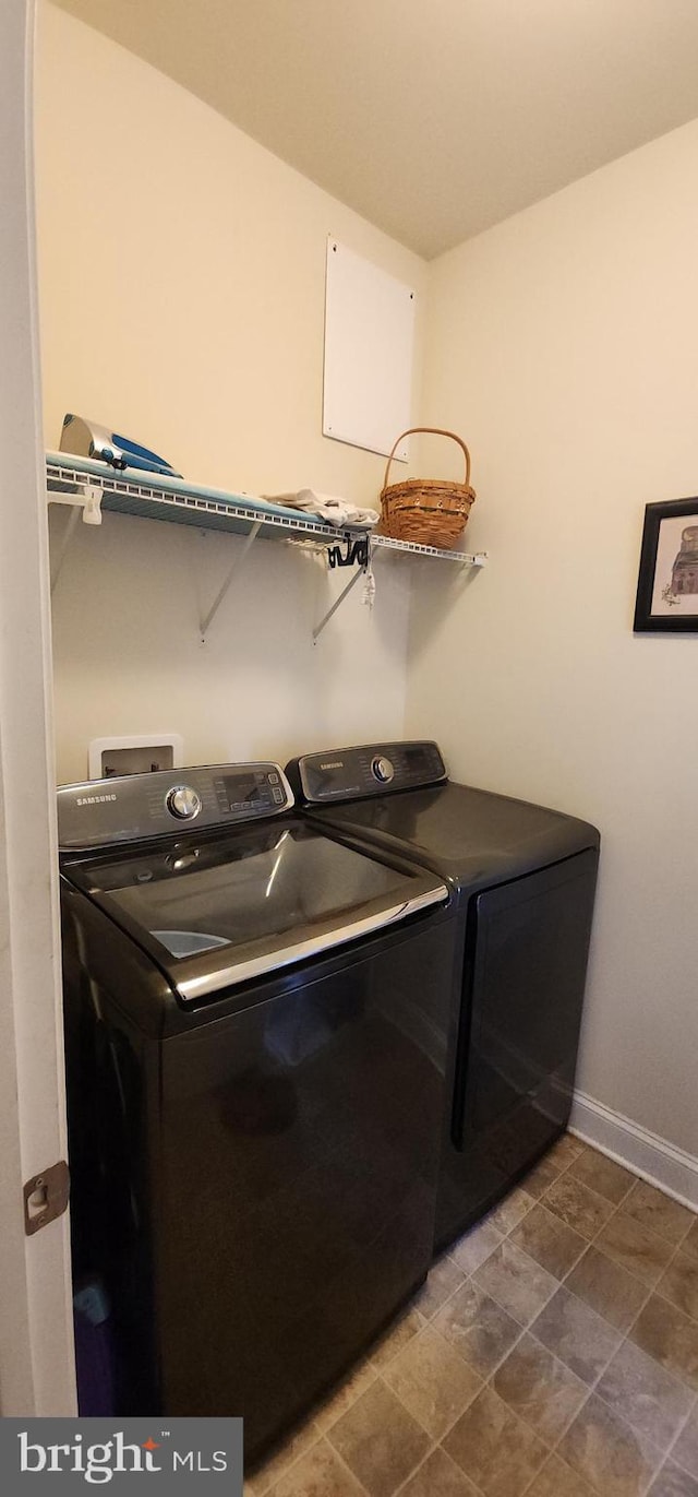 laundry room featuring washing machine and clothes dryer