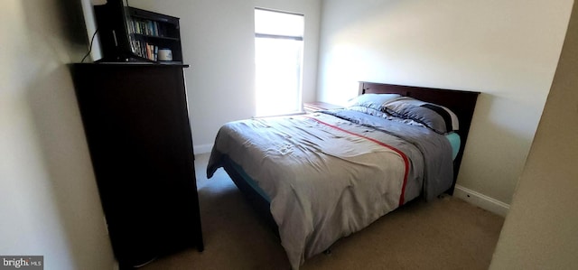 bedroom featuring light colored carpet