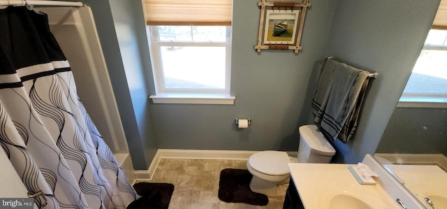 full bathroom with vanity, a healthy amount of sunlight, toilet, and shower / tub combo