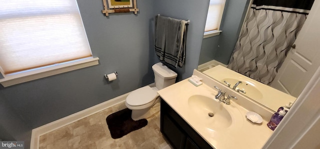 bathroom featuring walk in shower, vanity, and toilet