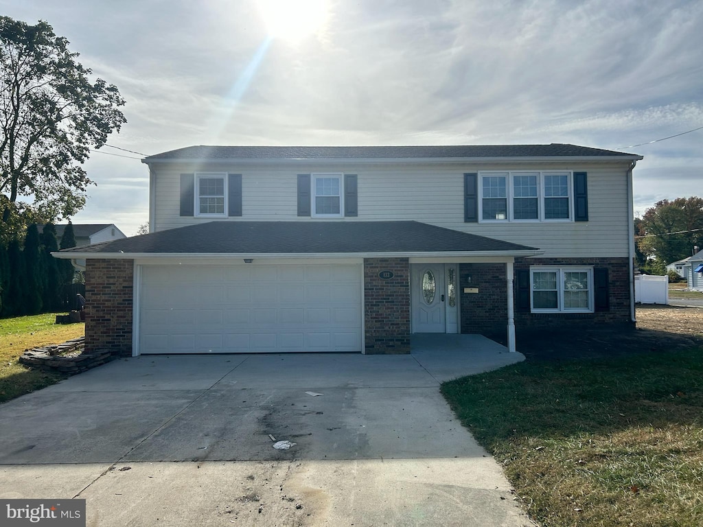 view of property with a front yard and a garage