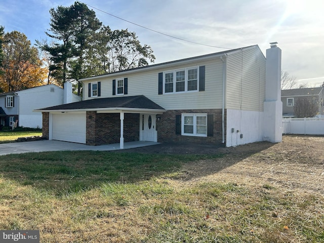 view of front property with a front yard and a garage