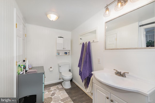 bathroom featuring vanity, wood-type flooring, and toilet