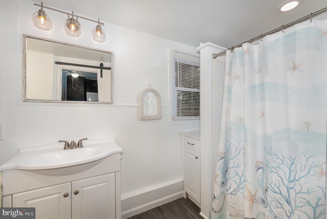 bathroom with a shower with shower curtain, vanity, and hardwood / wood-style floors