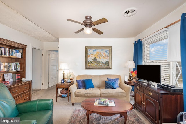 living room featuring ceiling fan and light carpet