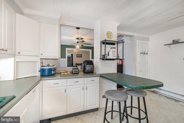 kitchen featuring white cabinetry, crown molding, a kitchen breakfast bar, white dishwasher, and kitchen peninsula