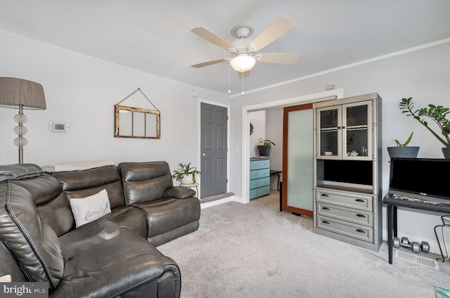 carpeted living room featuring ceiling fan