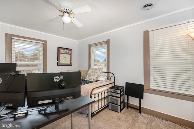 carpeted bedroom with ceiling fan and ornamental molding