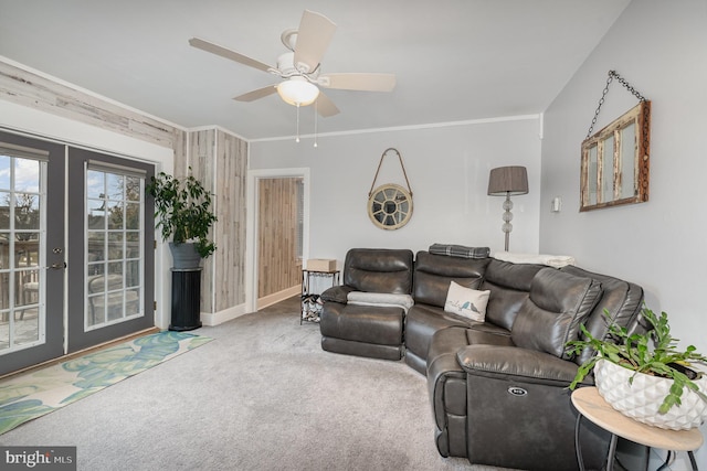 carpeted living room featuring crown molding, ceiling fan, and french doors