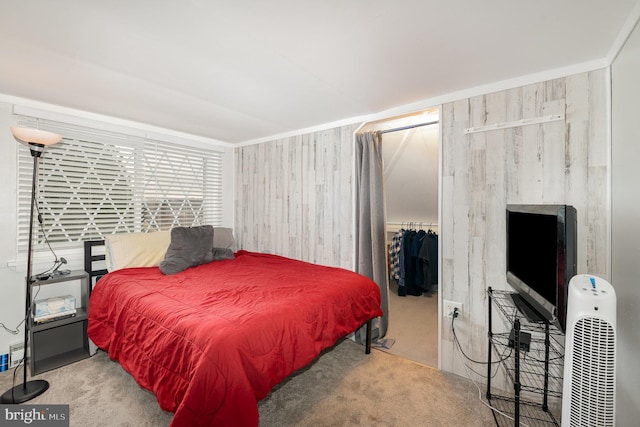 carpeted bedroom featuring a walk in closet and a closet