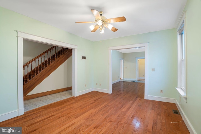 unfurnished room featuring ceiling fan and light wood-type flooring