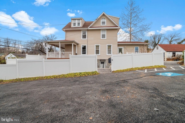 back of house featuring covered porch