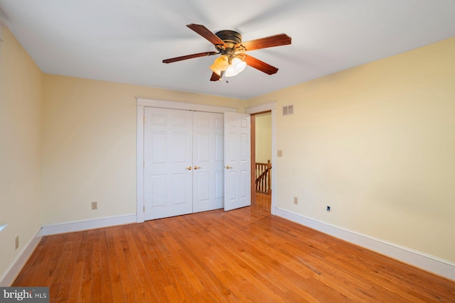 unfurnished bedroom featuring ceiling fan, a closet, and light hardwood / wood-style floors