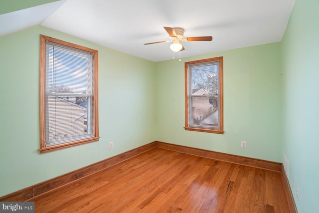 unfurnished room featuring hardwood / wood-style floors, ceiling fan, and lofted ceiling