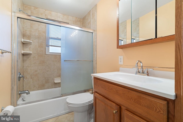 full bathroom featuring tile patterned flooring, vanity, toilet, and shower / bath combination with glass door