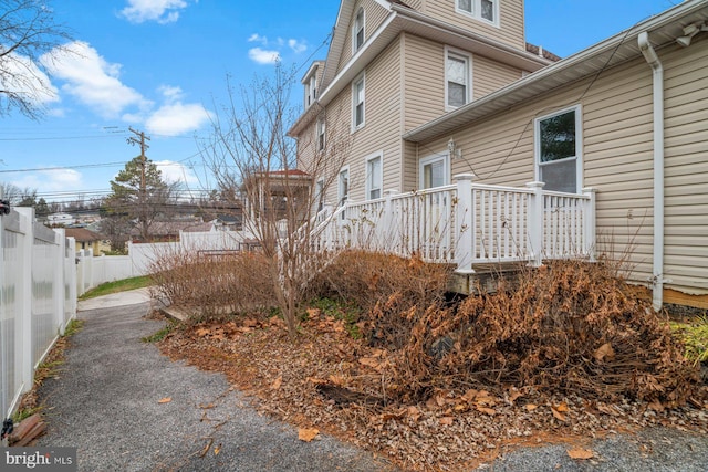 view of side of home featuring a wooden deck