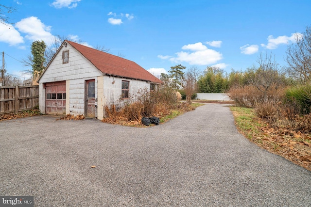 view of side of property with a garage and an outdoor structure