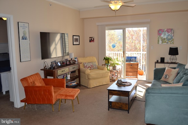 living room with crown molding, carpet floors, and ceiling fan