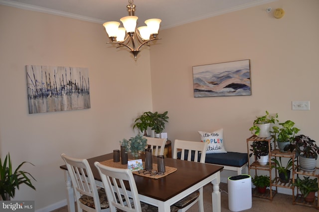 dining space featuring crown molding, carpet floors, and a chandelier