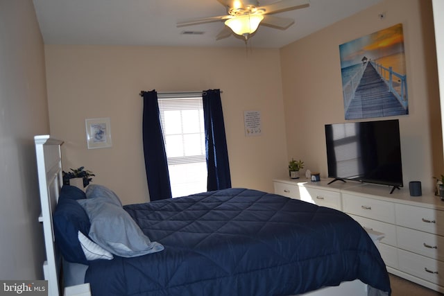 carpeted bedroom with ceiling fan and lofted ceiling