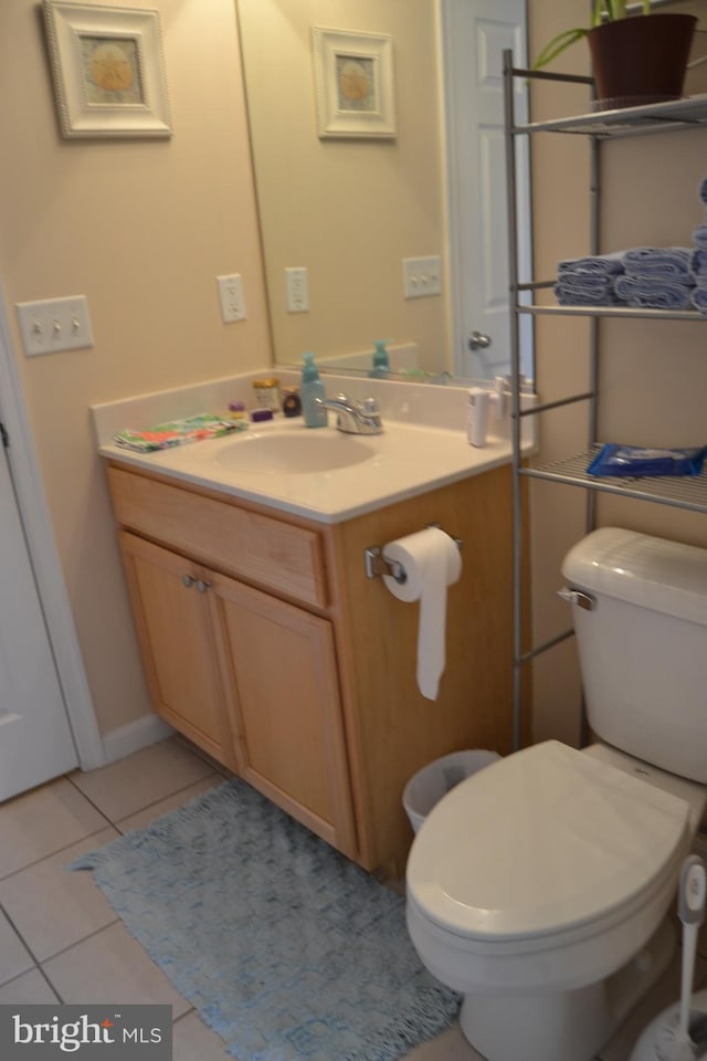 bathroom featuring toilet, vanity, and tile patterned floors