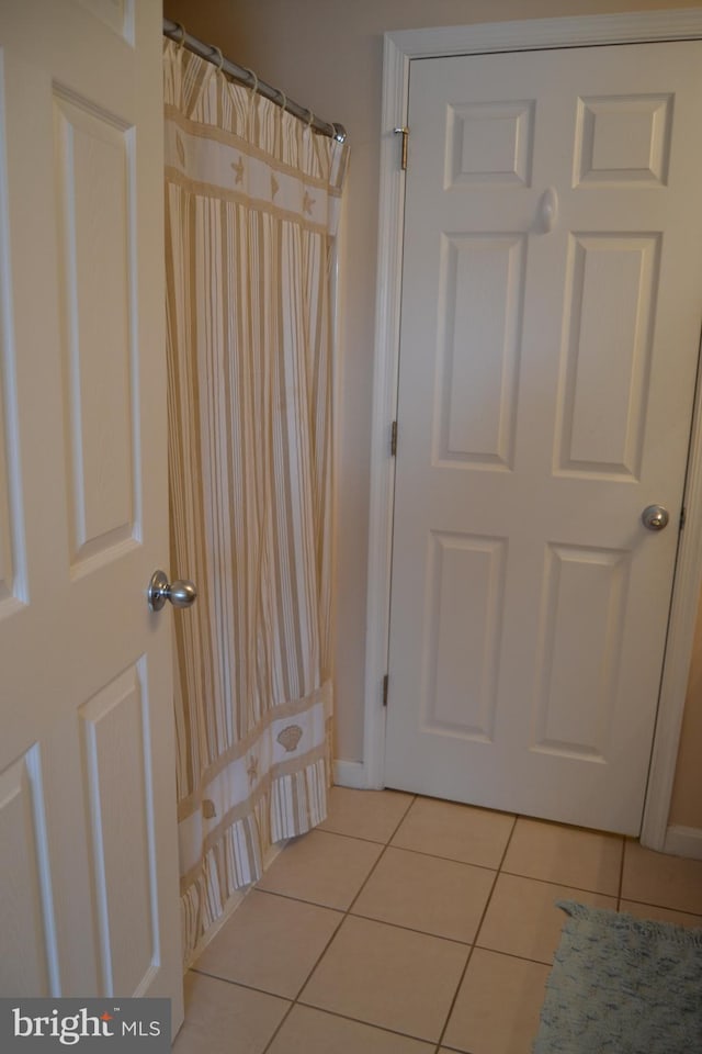 doorway to outside featuring light tile patterned floors