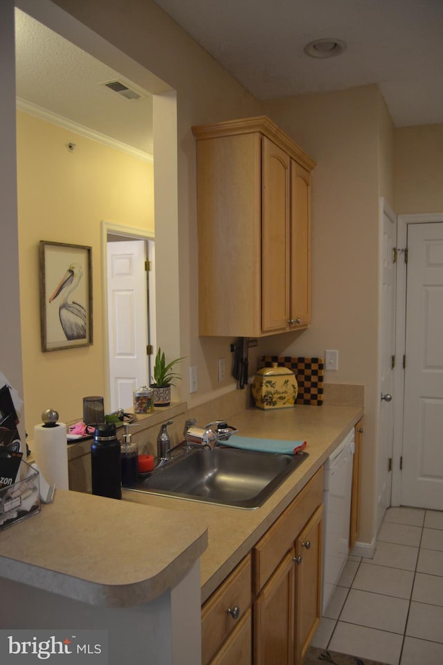 kitchen with kitchen peninsula, light brown cabinetry, white dishwasher, sink, and light tile patterned floors