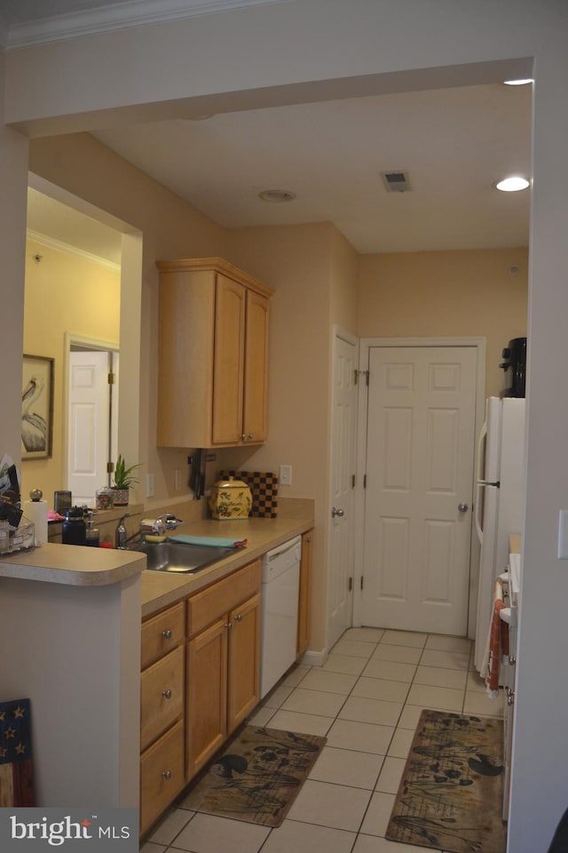 kitchen featuring white appliances, sink, light tile patterned floors, light brown cabinetry, and kitchen peninsula