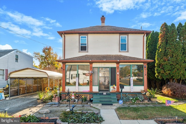 view of property featuring a carport and a porch