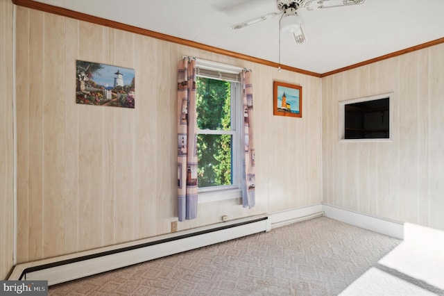 carpeted spare room with ceiling fan, ornamental molding, and a baseboard heating unit