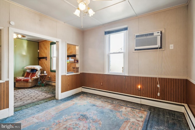 unfurnished room featuring wooden walls, carpet, and baseboard heating