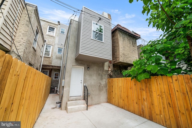 2442 Nicholas St, Philadelphia, PA 19121 - view of front of property with central air condition unit, entry steps, stucco siding, and fence