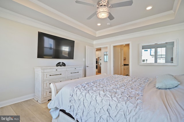 bedroom featuring ornamental molding, ceiling fan, and a tray ceiling