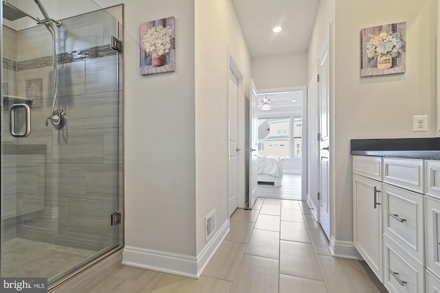 bathroom with vanity, tile patterned floors, and a shower with shower door