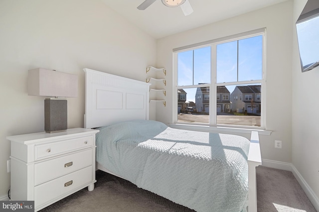 bedroom featuring ceiling fan and dark colored carpet