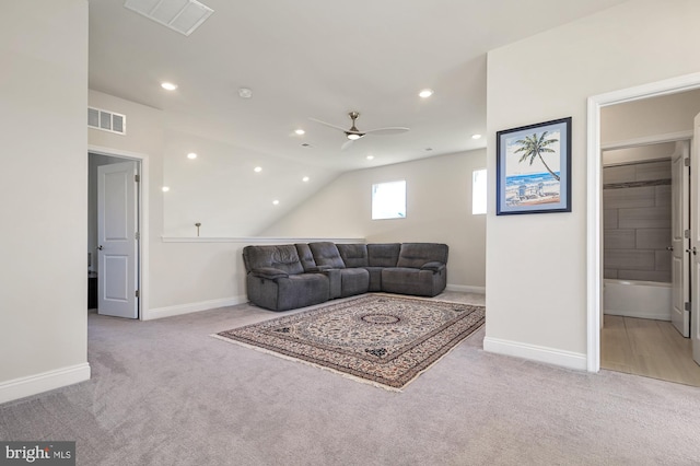 living room featuring light colored carpet, lofted ceiling, and ceiling fan