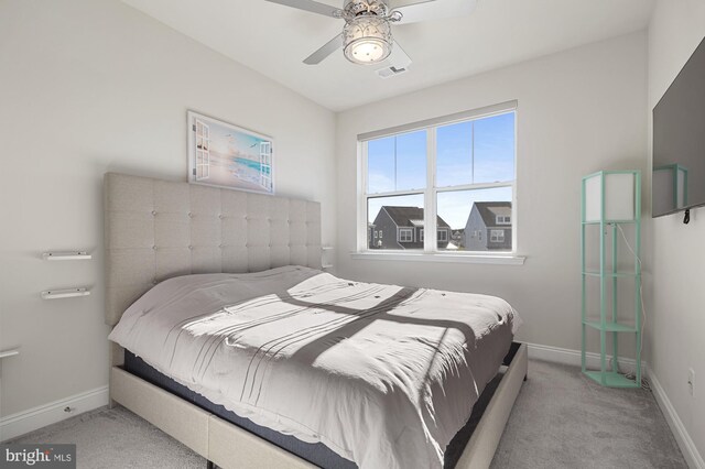 bedroom featuring light colored carpet and ceiling fan