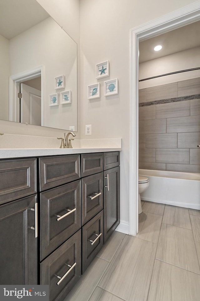 full bathroom with vanity, toilet, and tiled shower / bath combo