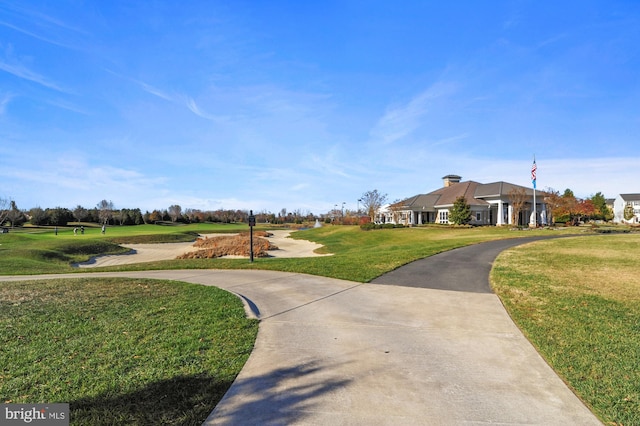 view of home's community with a yard