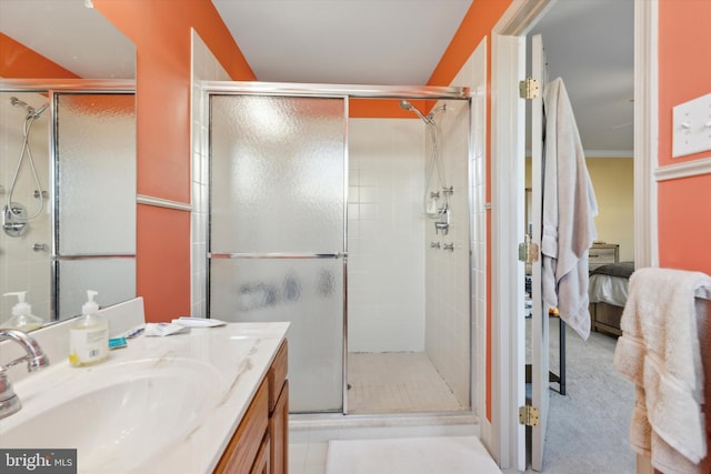 bathroom with vanity and a shower with door