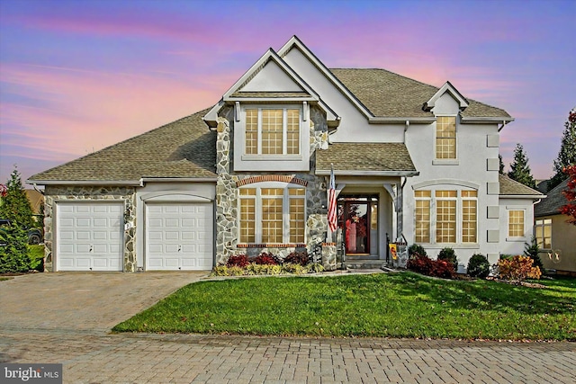 view of property with a garage and a yard