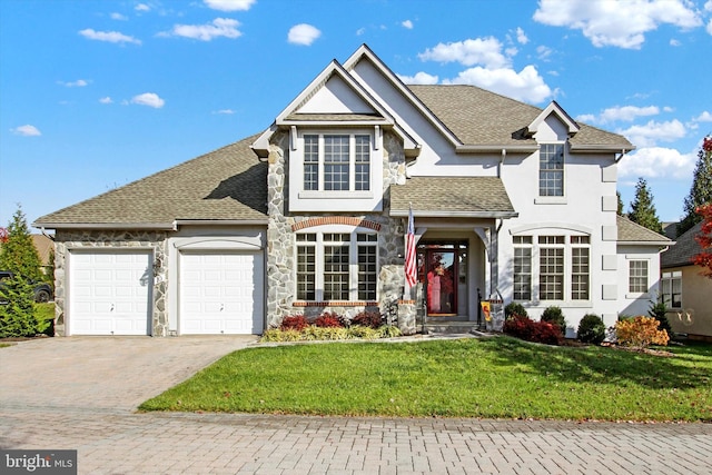 view of front property featuring a garage and a front yard