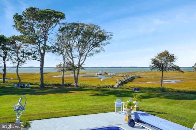 view of home's community with a lawn and a water view