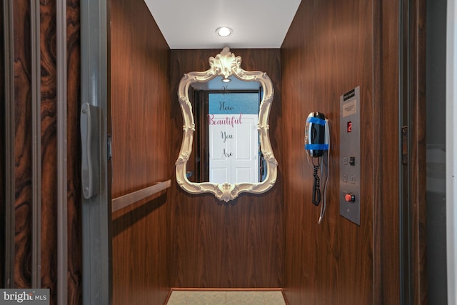 interior space featuring wooden walls and elevator